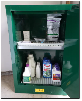 Figure 1. Photo shows a small cabinet designed for pesticides, displaying proper storage of pesticides.